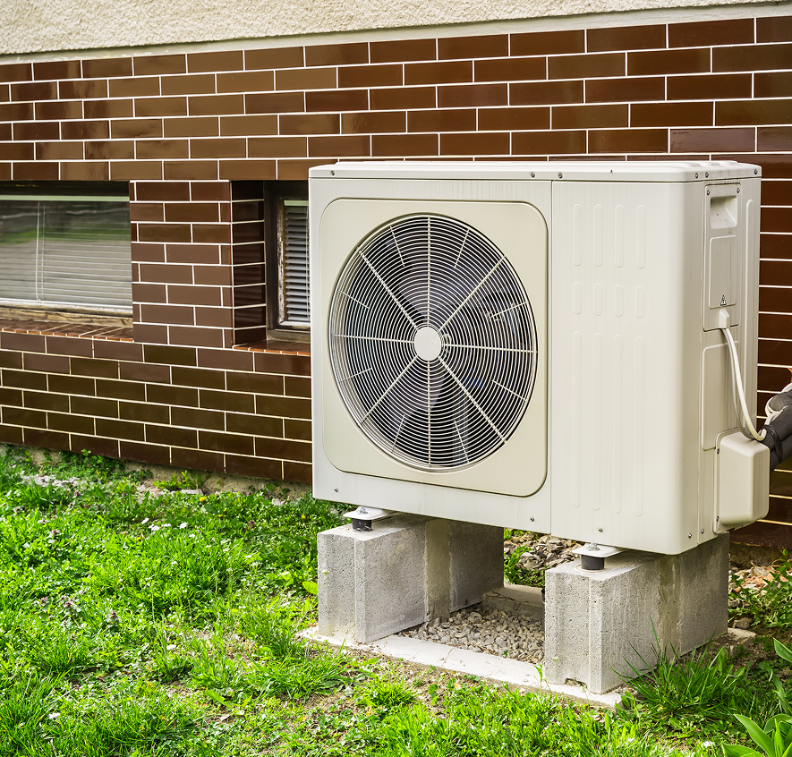Outdoor air conditioning unit beside brick wall