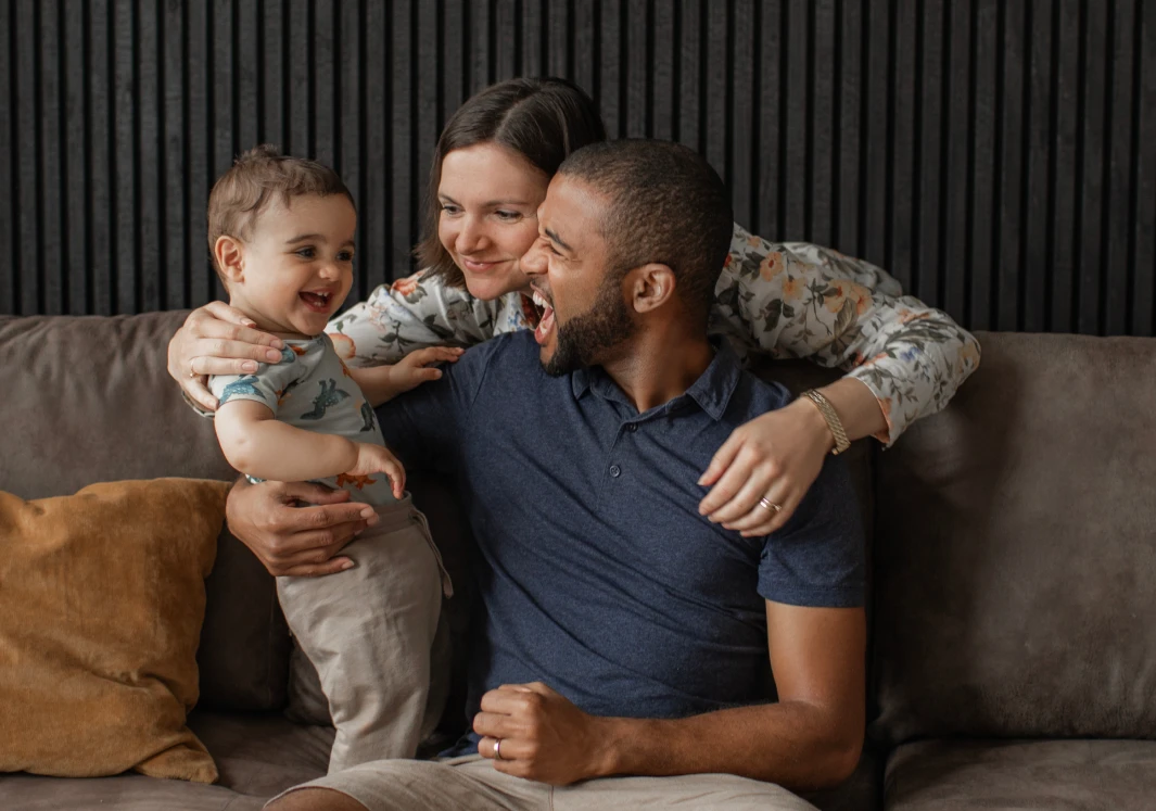 Happy family enjoying playful moment on sofa